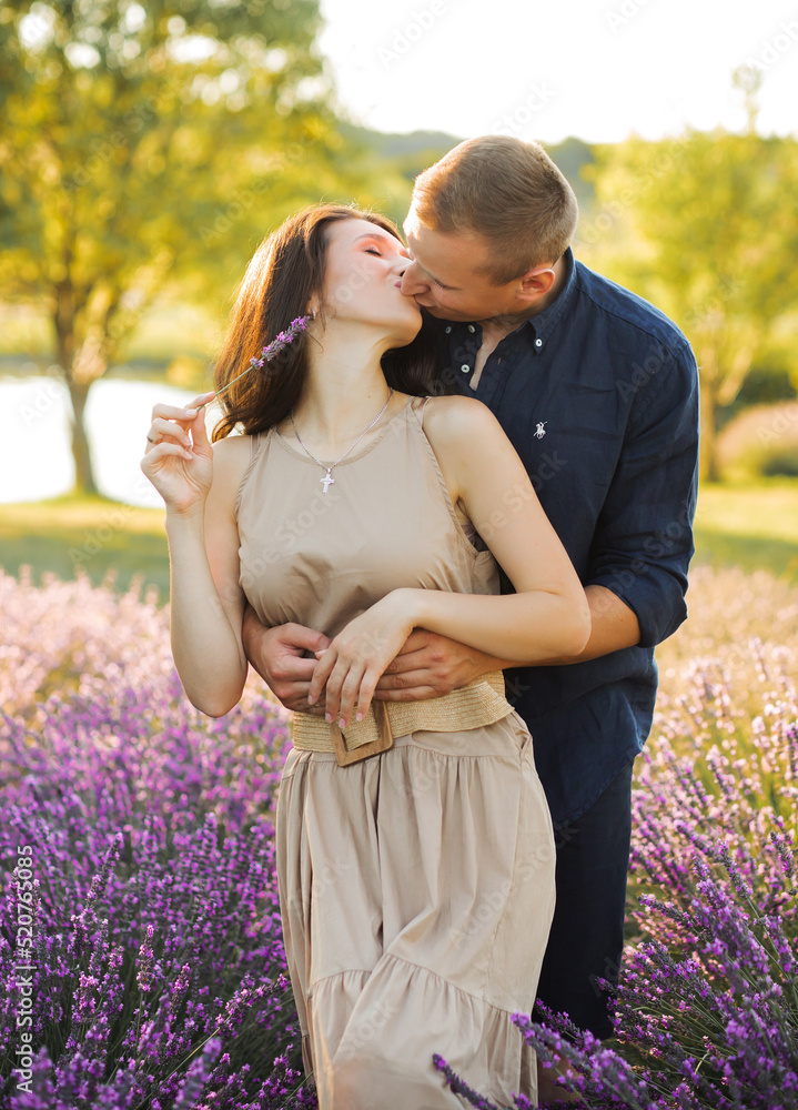 Beautiful couple in love hugging in lavender field Beautiful couple in love hugging in lavender field
