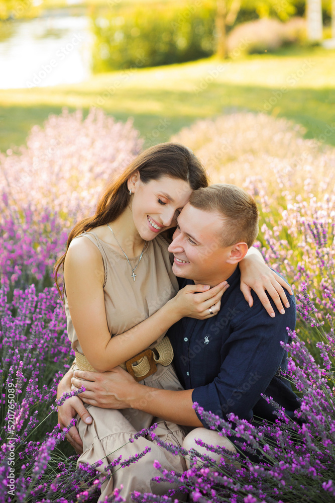 Beautiful couple in love hugging in lavender field Beautiful couple in love hugging in lavender field