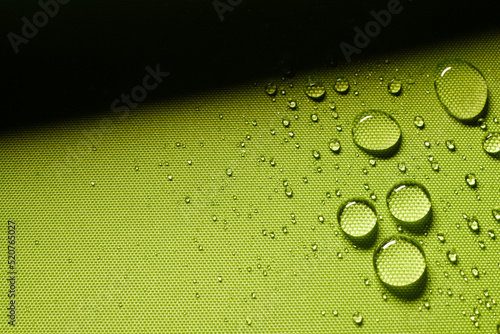 Green textile with water drops photo