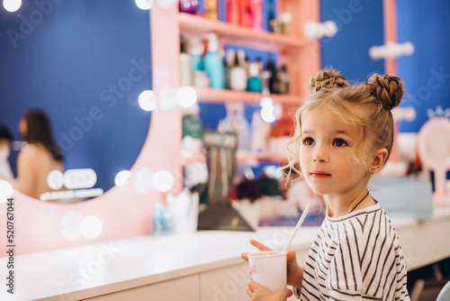 Portrait of a little beautiful girl with a stylish hairstyle in a beauty salon