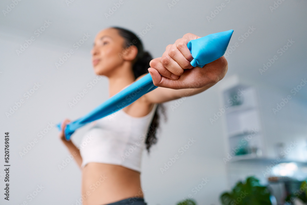 Close up of hands stretching resistance band in home workout Close up of hands stretching resistance band in home workout