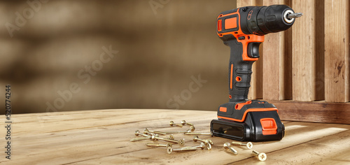 Black and orange drill on workshop and free space for your decoration. 