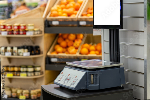 Mock-up of electronic trading scales in a supermarket on a blurred background of goods