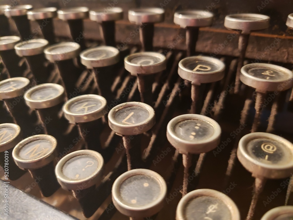 Closeup business and office themed studio shot of the typing keys of an antique typewriter. Closeup business and office themed studio shot of the typing keys of an antique typewriter.