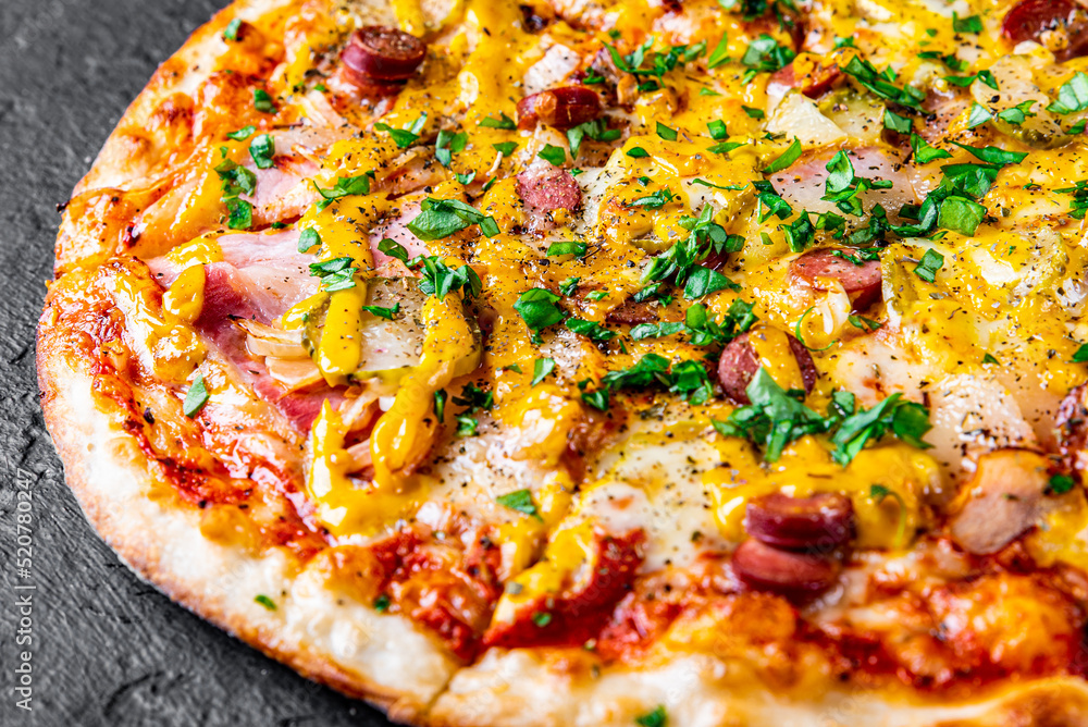 Pizza with Mozzarella cheese, backon, ham, tomato sauce, pepper, sausage. Italian pizza on Dark grey black slate background Pizza with Mozzarella cheese, backon, ham, tomato sauce, pepper, sausage. Italian pizza on Dark grey black slate background