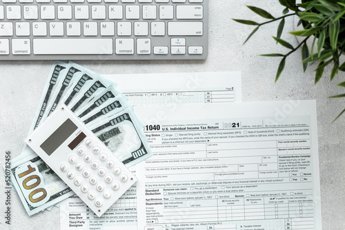 Annual tax form under US law with culculator. Tax payment concept photo