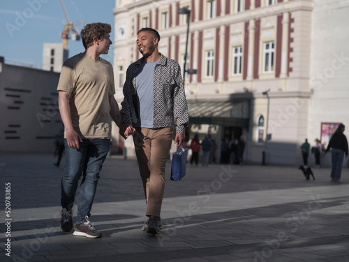 UK, South Yorkshire, Smiling gay couple holding hands in city