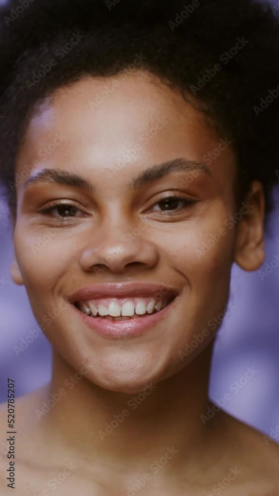 African American model smiling looking at camera standing of falling rose petals African American model smiling looking at camera standing of falling rose petals
