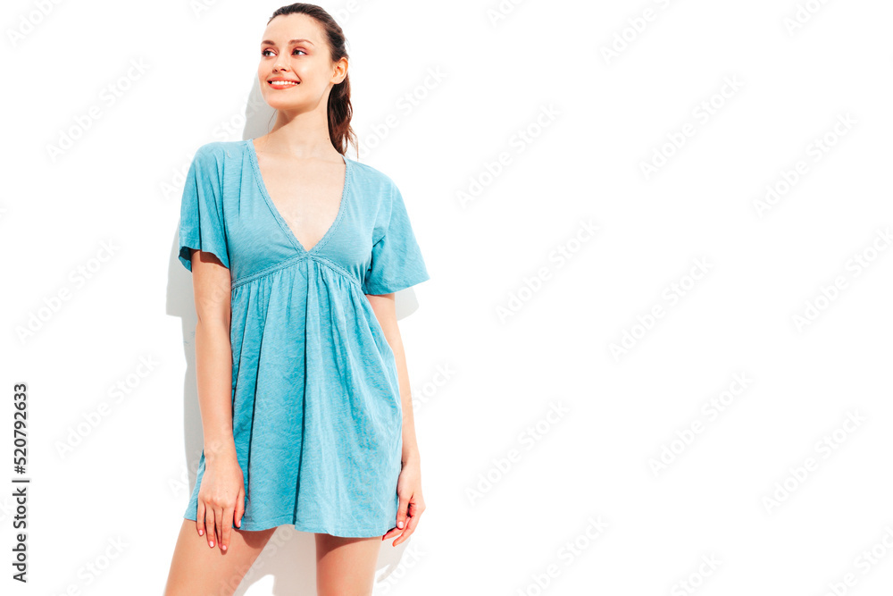 Young beautiful smiling female in trendy summer blue dress. Sexy carefree woman posing near white wall in studio. Positive model having fun and going crazy. Cheerful and happy Young beautiful smiling female in trendy summer blue dress. Sexy carefree woman posing near white wall in studio. Positive model having fun and going crazy. Cheerful and happy