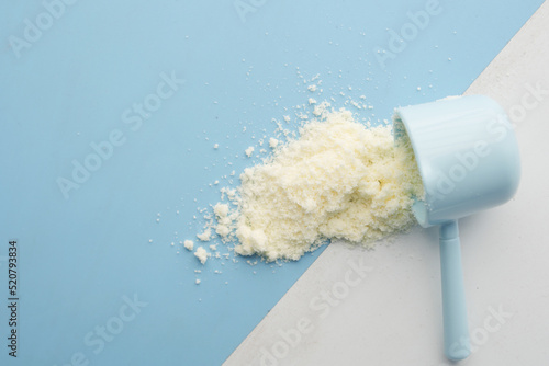 Photos Close up of baby milk powder and spoon on tile background.