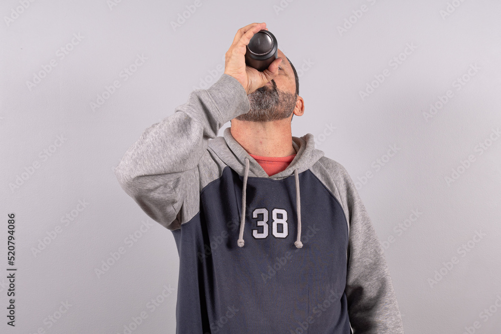 Close-up man in his 60s wearing eyeglasses, against gray wall background with copy space Close-up man in his 60s wearing eyeglasses, against gray wall background with copy space