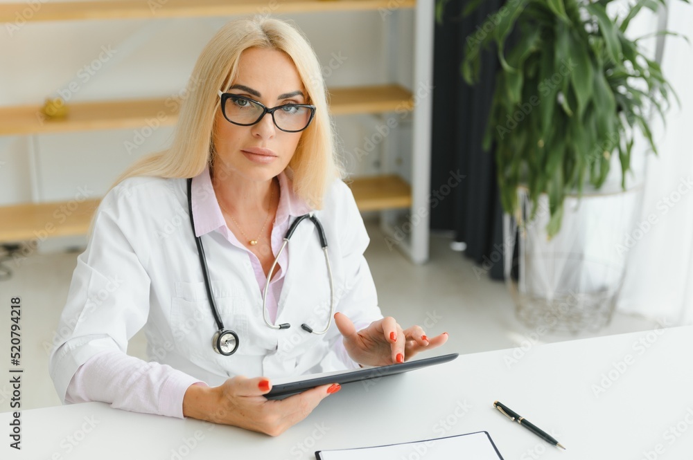 Middle age woman wearing doctor uniform at clinic Middle age woman wearing doctor uniform at clinic