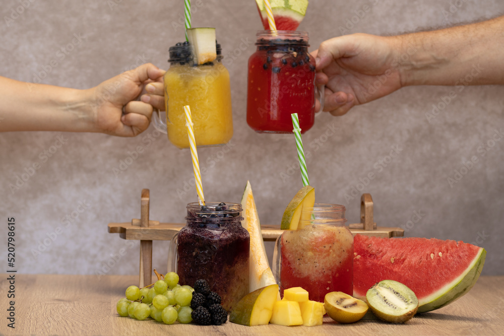cold fruit juices or ice cream in glass jars. four types of juices of