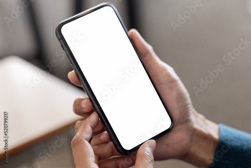 cell phone blank white screen mockup.hand holding texting using mobile on desk at office.background empty space for advertise.work people contact marketing business,technology