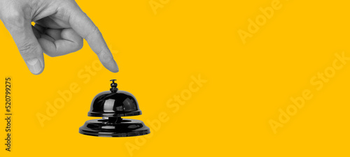 Banner with forefinger pressing on call bell on orange background. Paying attention concept. Stationary construction used in hotel, restaurant, store. Copy space. High quality photo