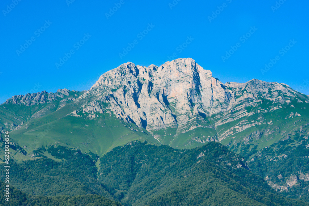 Mountain and amazing nature. Peak of the mountain. Top of Mount Khustup. Blue sky and beautiful mountain Mountain and amazing nature. Peak of the mountain. Top of Mount Khustup. Blue sky and beautiful mountain