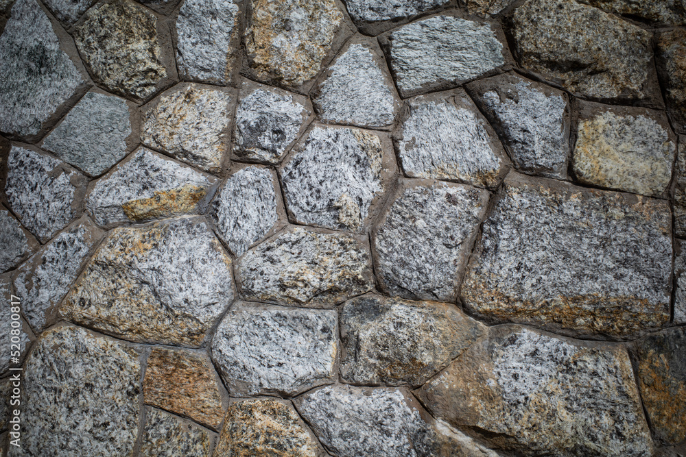 Background texture of Rough stone wall, Stone cladding, Old castle stone wall, Grey, brown Color, Close up shot Background texture of Rough stone wall, Stone cladding, Old castle stone wall, Grey, brown Color, Close up shot