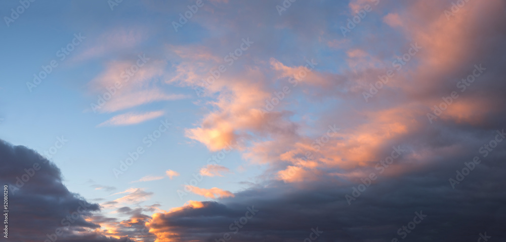 grey cloud cover with blue sky and pink cumulus above grey cloud cover with blue sky and pink cumulus above