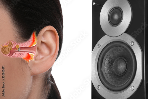 Modern audio speaker and woman listening to music on white background, closeup view of ear photo