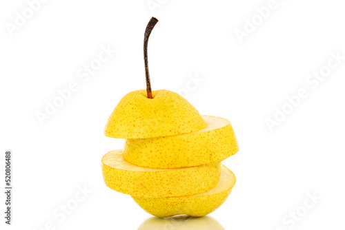 One juicy yellow pear cut into quarters  close-up  isolated on a white background.