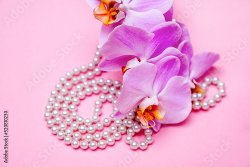Fototapeta Naklejka Na Ścianę i Meble -  Pearl necklace and Purple orchid on pink background
