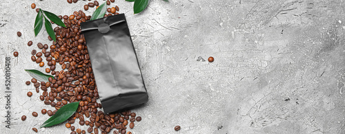Coffee bag and beans on grey background with space for text