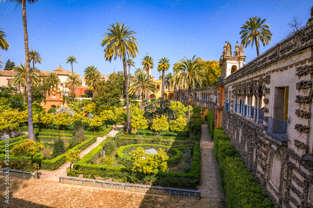 Beautiful formal public garden inside Alcazar Seville palace in summertime in Andalusia Beautiful formal public garden inside Alcazar Seville palace in summertime in Andalusia
