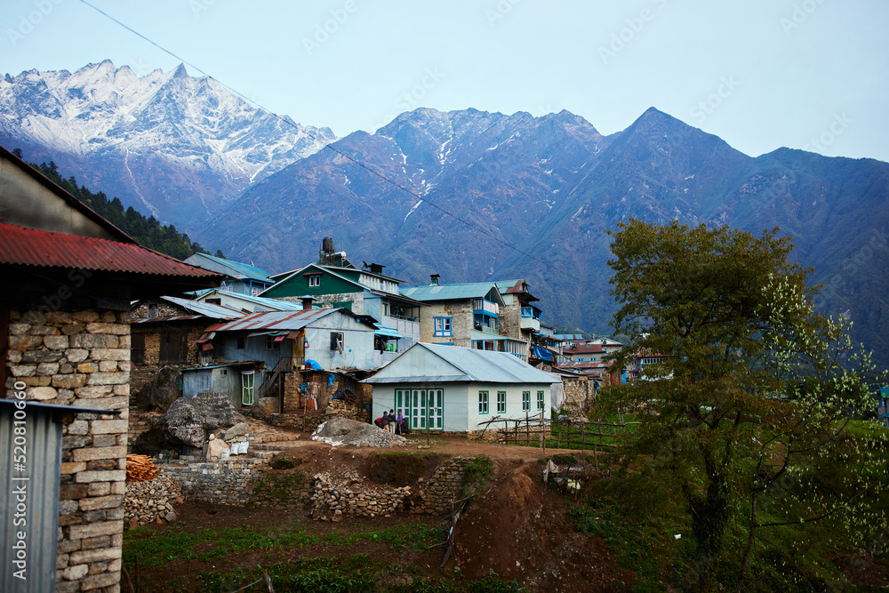 a mountain view at Lukla nepal of normal houses in nepalese country side on the mountain everest base camp trek green travel activities