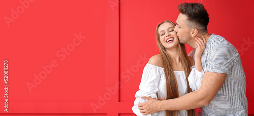 Young man kissing his girlf...