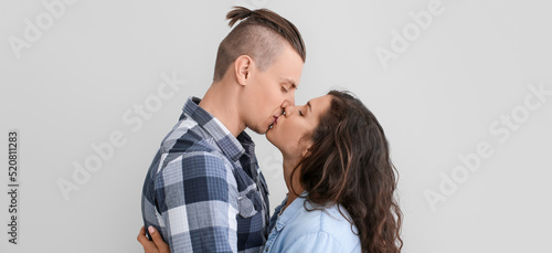 Kissing young couple on lig...