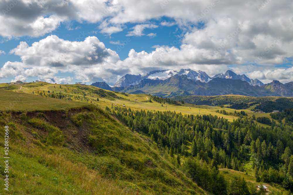 View of Marmolada montain on the background, the queen of Dolomites alps from the path to Pralongià refuge, Italy.