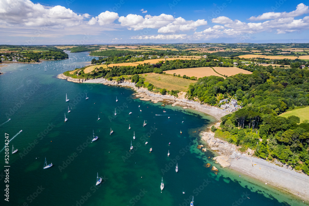 Aerial shot of Helford river, rural landscape, villages, beaches, water and boats. Cornwall UK