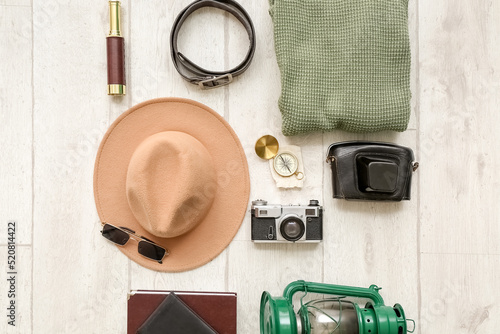 Male accessories for travelling with photo camera on white wooden background © Pixel-Shot