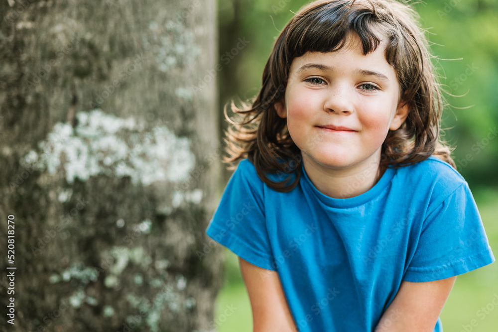 Cute little girl near tree Stock Photo | Adobe Stock