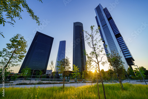 Four business skyscrapers of the business district at sunset in Madrid, Spain.