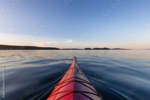 Sea Kayak paddling in the Pacific Ocean. Colorful Sunset Sky. Taken near Victoria  Vancouver Islands  British Columbia  Canada. Concept  Sport  Adventure