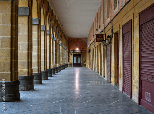 arcade of the plaza de la Constitución in San Sebastián deserted and clean on a cold winter morning.
