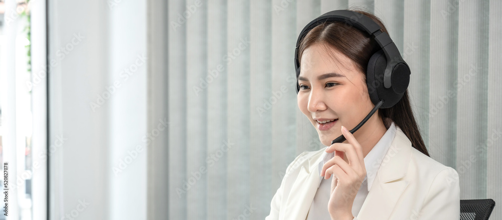 Female call center provides information to a customer calling for help, Contact us, Service with a beautiful and friendly voice, Long distance communication, Talk using headphones or headsets Female call center provides information to a customer calling for help, Contact us, Service with a beautiful and friendly voice, Long distance communication, Talk using headphones or headsets
