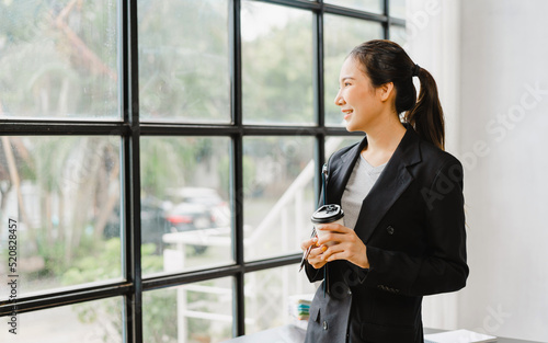 successful confident pretty asian business woman standing in the office and looking to camera. Free Download successful confident pretty asian business woman standing in the office and looking to camera. - GFXLoad