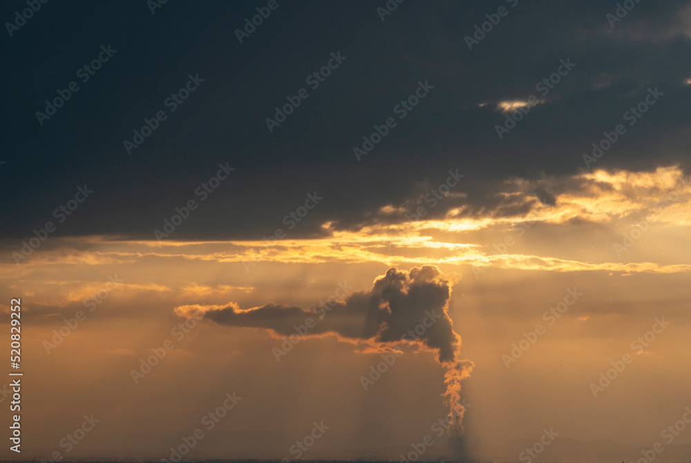 smoke from the chimney of a nuclear power plant at sunset