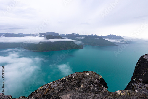 foggy view of the Fjordgard from Hesten trail to the Segla mountain on Senja island in northern Norway. photo