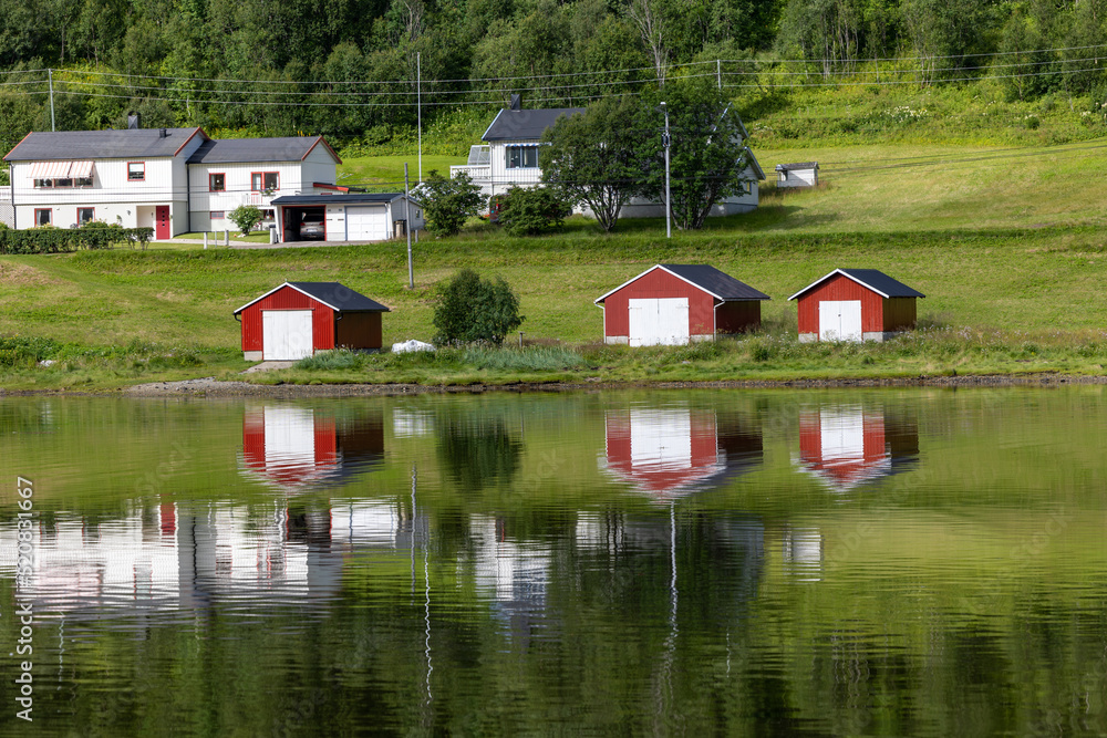 a beautiful Rorbu on a fjord in northern norway, typical fishermen's houses, Finnmark, Norway a beautiful Rorbu on a fjord in northern norway, typical fishermen's houses, Finnmark, Norway