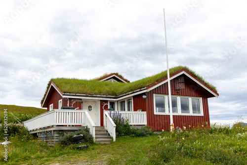 Traditional red wooden house with green grass roof, Troms og Finnmark, North Norway