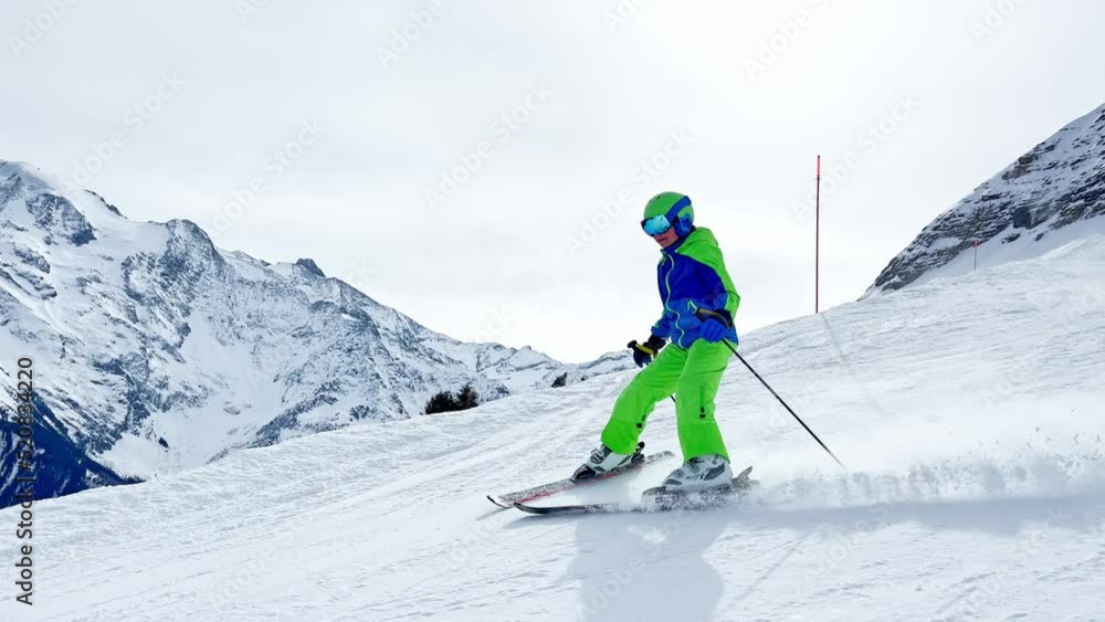 Side view of the boy ski fast downhill over Mont Blanc Side view of the boy ski fast downhill over Mont Blanc