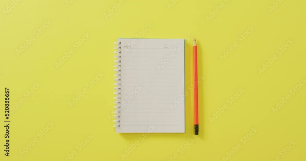 Video of notebook with copy space and pencil on yellow background Video of notebook with copy space and pencil on yellow background