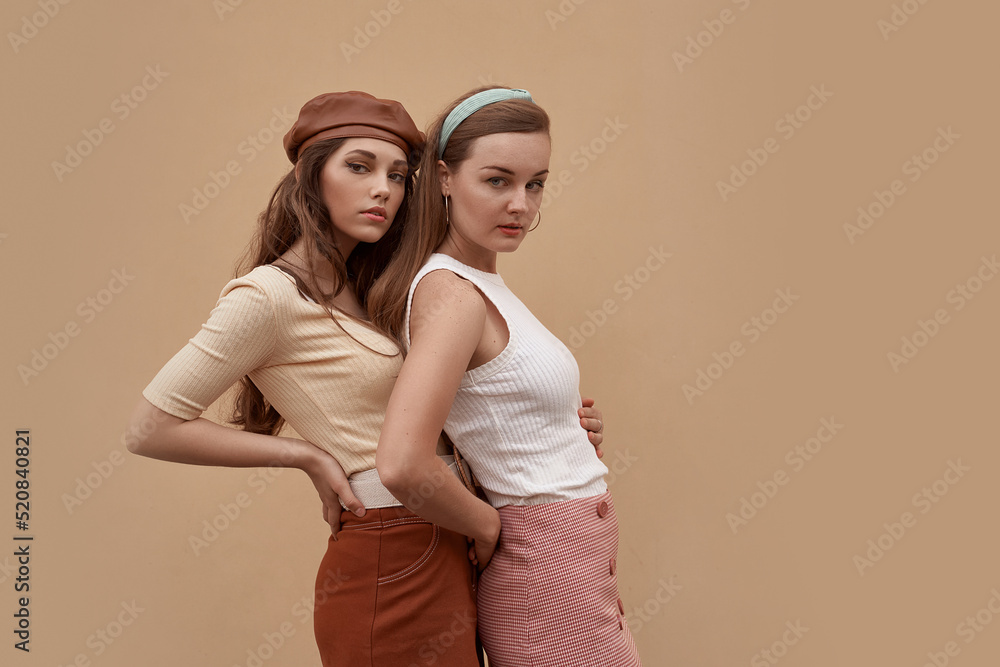 Young beautiful models dressed in retro vintage style enjoying the old european city summertime lifestyle. Old fashioned clothes.