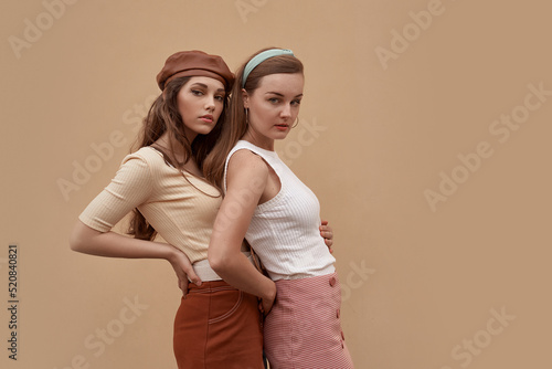 Obraz na płótnie Young beautiful models dressed in retro vintage style enjoying the old european city summertime lifestyle. Old fashioned clothes. w salonie