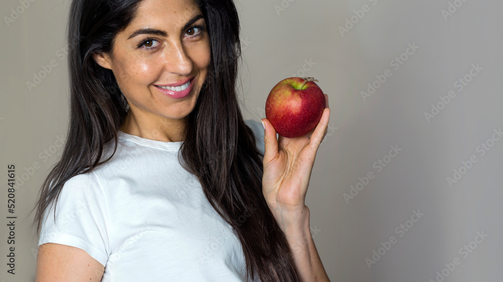 Beautiful Young Woman Holding Red Apple. Healthy Eating and Dental Care Concept Beautiful Young Woman Holding Red Apple. Healthy Eating and Dental Care Concept