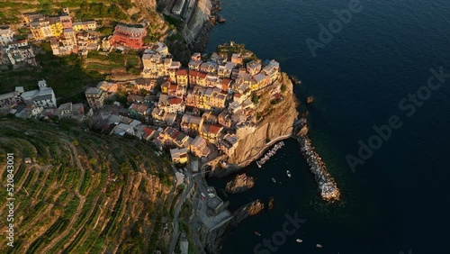 View from above, stunning aerial view of Manarola, the second village of the Cinque Terre coming from La Spezia. Manarola is the most picturesque village, made up of colorful tower-houses.