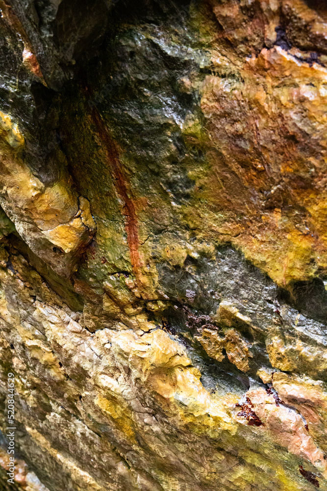 rocks near the beach with a great variety of veins of different colors and minerals, live and natural colored rocks rocks near the beach with a great variety of veins of different colors and minerals, live and natural colored rocks